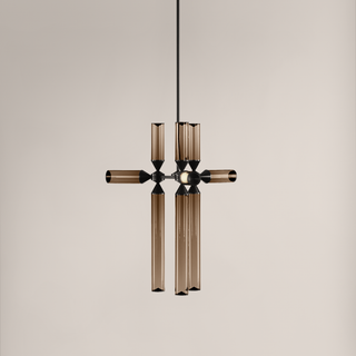 Modern pendant light with brown glass shades on a beige background
