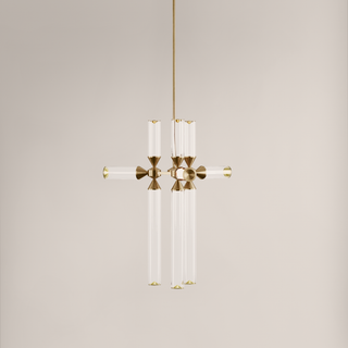 Modern pendant light with gold fixture and clear glass on a neutral background
